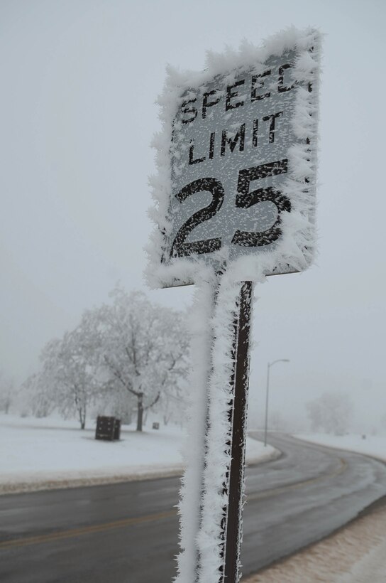 ELLSWORTH AIR FORCE BASE, S.D.--  A speed limit sign is surrounded by ice, Dec. 22. For road condition updates and reporting situations, call (605) 385-ROAD (7623) or visit the Ellsworth Air Force Base Web site at www.ellsworth.af.mil (U.S. Air Force photo/Airman 1st Class Corey Hook)