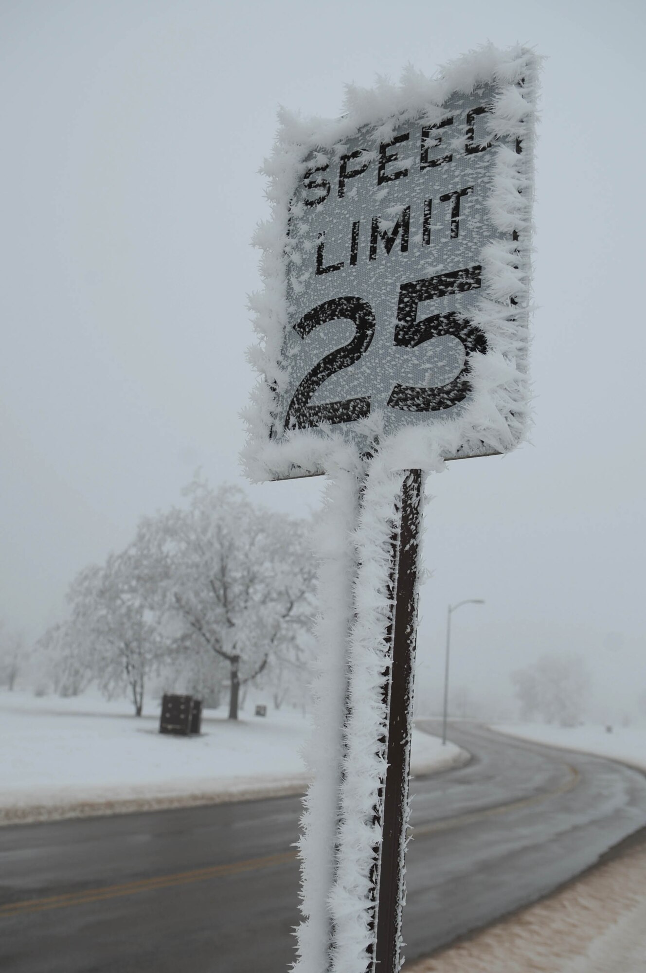 ELLSWORTH AIR FORCE BASE, S.D.--  A speed limit sign is surrounded by ice, Dec. 22. For road condition updates and reporting situations, call (605) 385-ROAD (7623) or visit the Ellsworth Air Force Base Web site at www.ellsworth.af.mil (U.S. Air Force photo/Airman 1st Class Corey Hook)