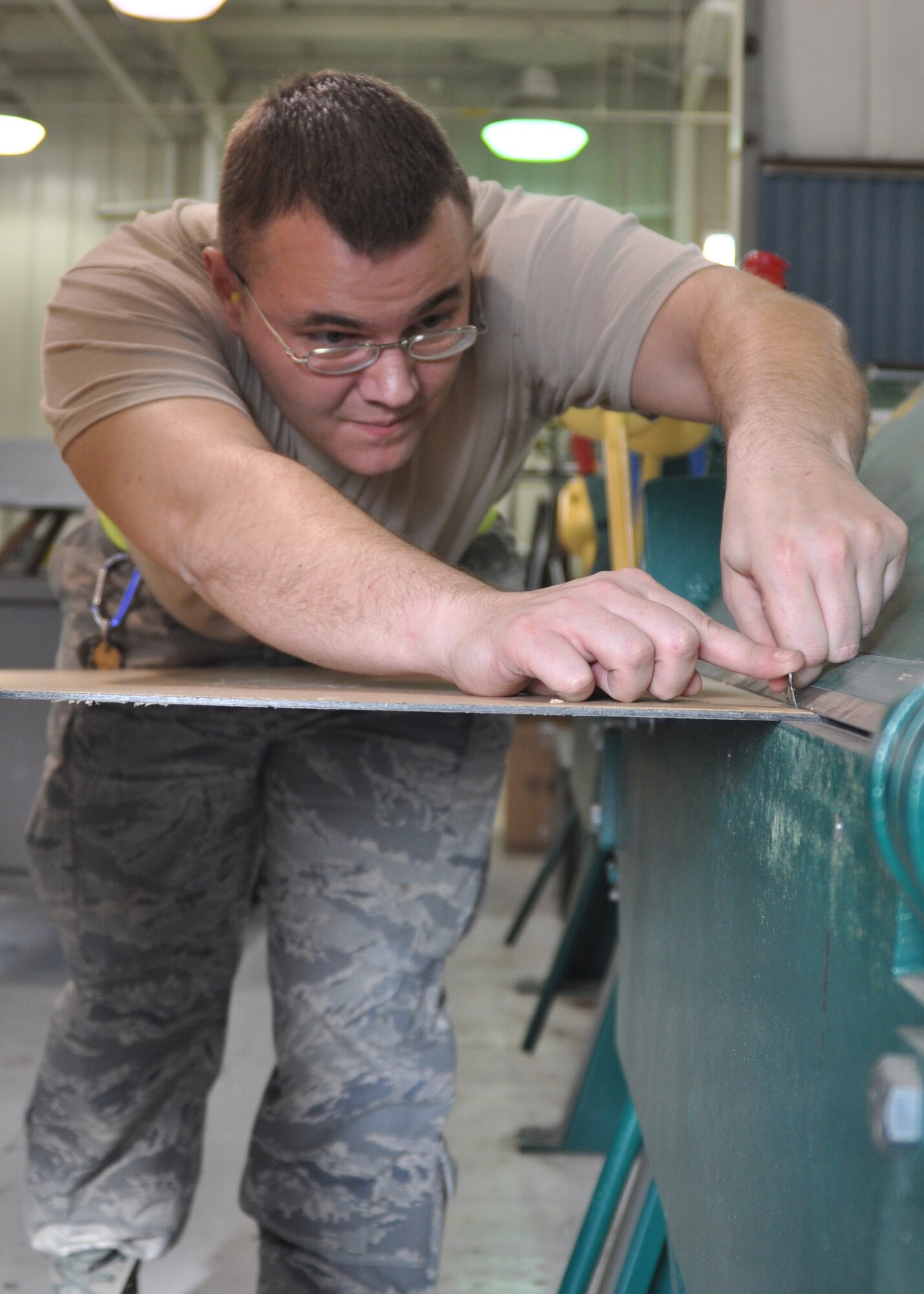 Airman 1st Class David Shellgren, an aircraft structural maintenance technician working in the 917th Maintenance Squadron Fabrications Shop (MXMFS) at Barksdale Air Force Base, La., takes a razor to materials being used for a project in the shop December 28, 2009. Airman Shellgren, an active duty Airman from the 2nd Bomb Wing here, has been in the 917th Fabrications Shop since July 2009 in support of Total Force Integration. He is just one of the Airmen on Barksdale tasked to maintain and repair the B-52 Stratortresses and A-10 Thunderbolts here. (U.S. Air Force Photo/ Senior Airman Crystal Marie Jordan)