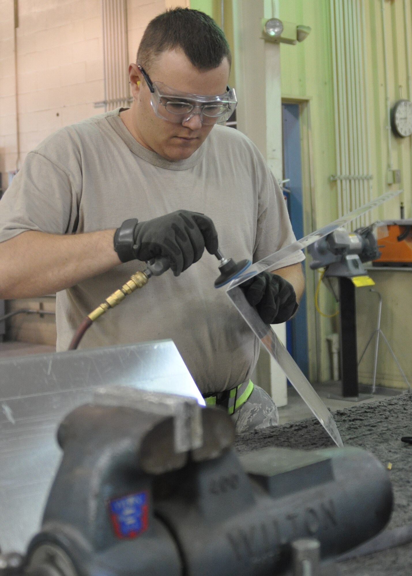 Airman 1st Class David Shellgren, an aircraft structural maintenance technician working in the 917th Maintenance Squadron Fabrications Shop (MXMFS) at Barksdale Air Force Base, La., buffs out metal being used for a project in the shop December 28, 2009. Airman Shellgren, an active duty Airman from the 2nd Bomb Wing here in support of Total Force Integration, maintains and repairs B-52 Stratofortresses and A-10 Thunderbolt IIs alongside 917th Wing reserve Airmen here since July 2009. (U.S. Air Force Photo/ Senior Airman Crystal Marie Jordan)