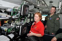 Christine Kepler, emergency manager of the Miami Veterans Affairs Healthcare System, explains the capabilities of their patient evacuation vehicles to Master Sgt. Zac Johnson, 934th AES. 