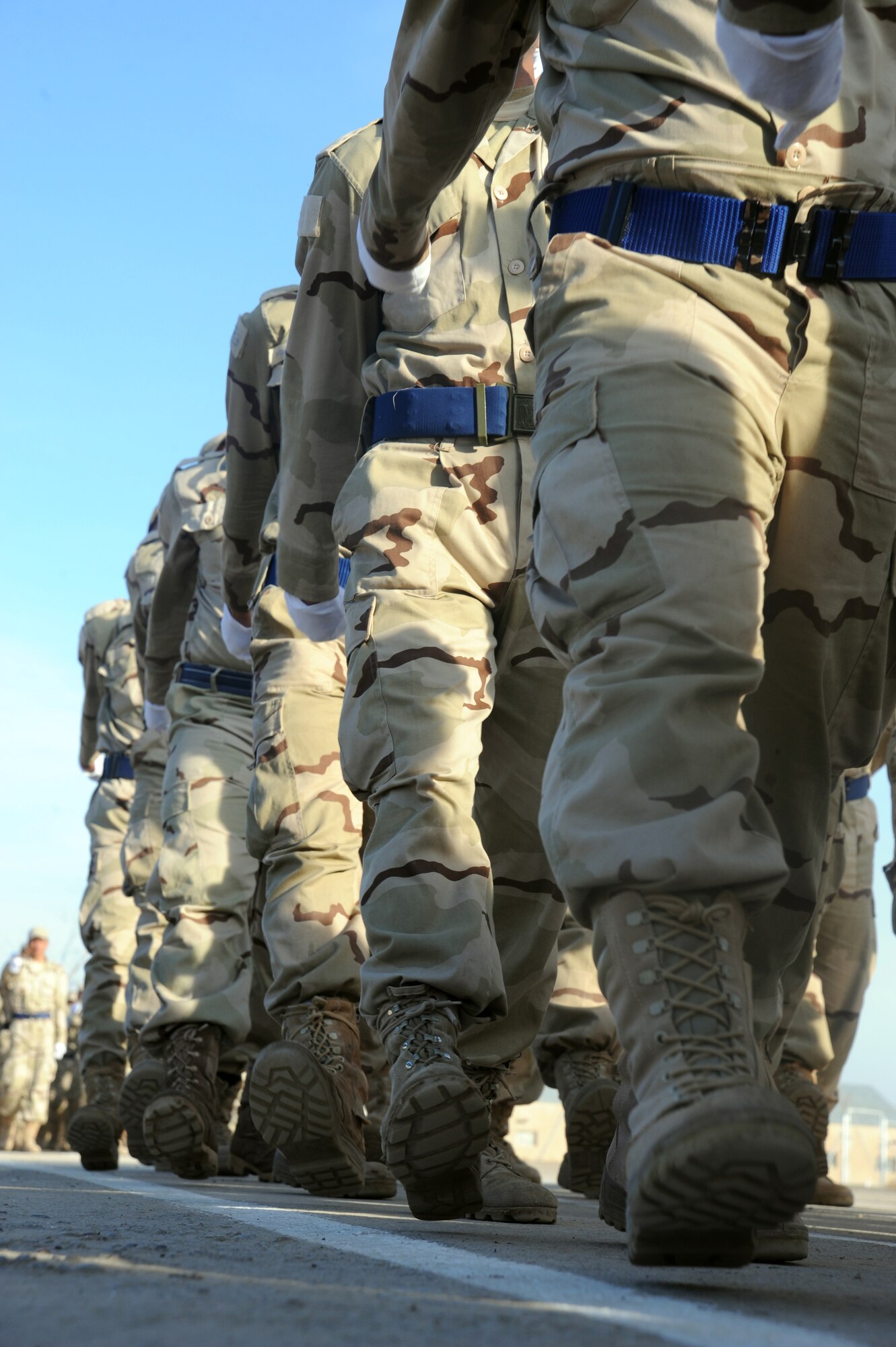 CAMP TAJI, Iraq -- Iraqi air force recruits march in a pass in review parade during their graduation ceremony from the basic military training Top Off course at the Iraqi Air Force Training School Dec. 28, 2009.  The staff incorporated discipline, marching and drill during the morning sessions and academics in the afternoon. (U.S. Air Force photo/Master Sgt. Trish Bunting)
