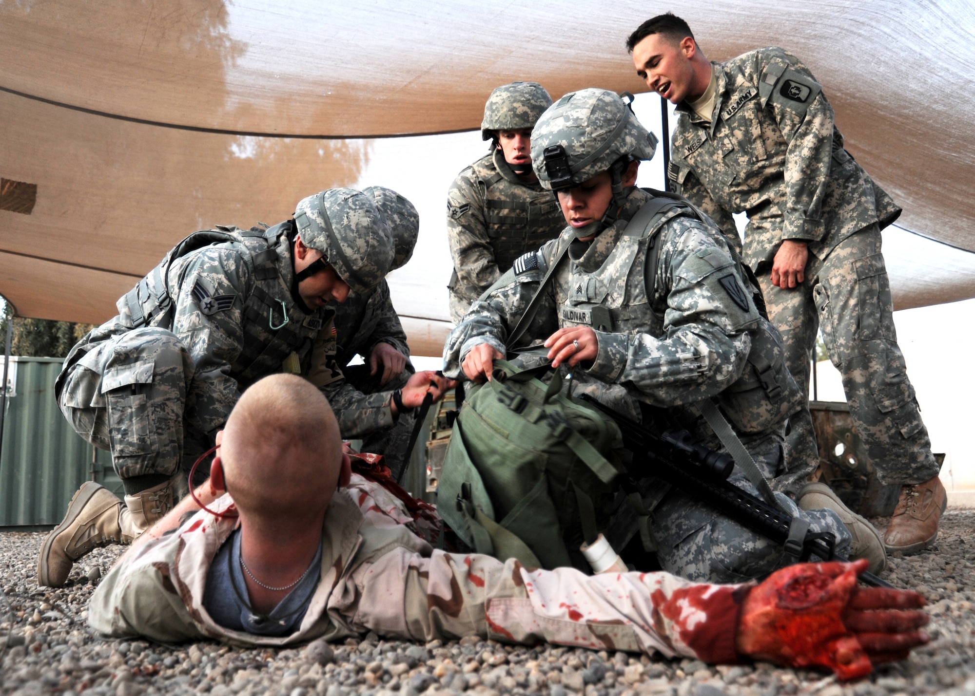 Airmen and Soldiers work together as they respond to a simulated mass casualty exercise during a combat lifesaver course Dec. 11, 2009. Instructors of the 1st Medical Battalion qualify approximately 200 students a month on tactical life-saving skills through the course. (U.S. Air Force photo/Senior Airman Christopher Hubenthal/Released)