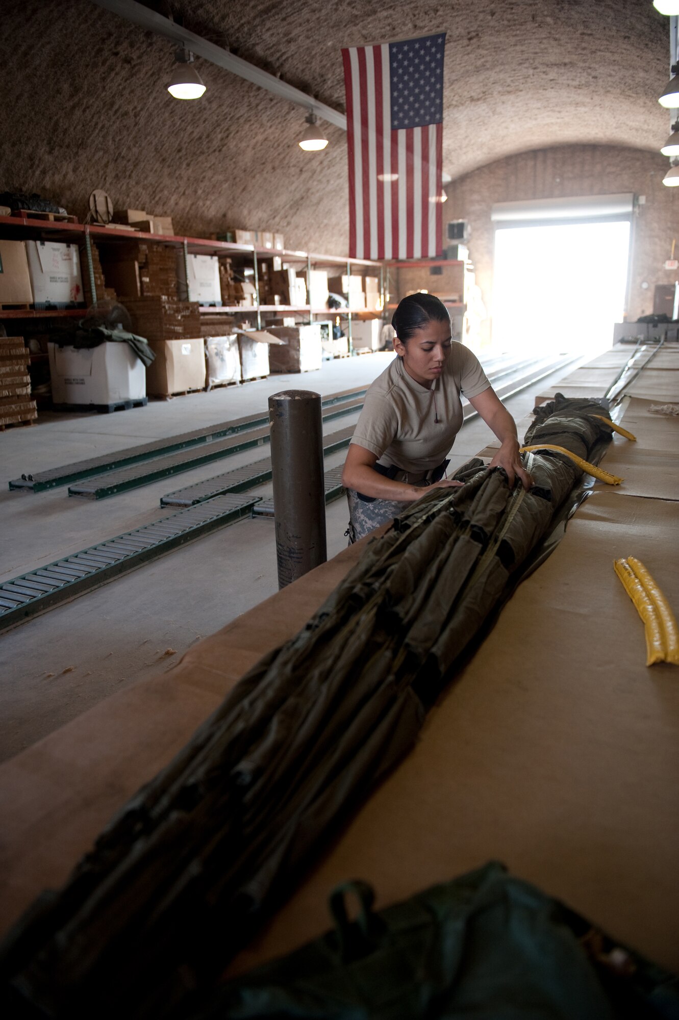 U.S. Army Spc. Diana Vega, 824th Quarter Master Company Heavy Airdrop Supply Detachment 8, packages a parachute in preparation for an airdrop, Dec. 29, 2009, in Southwest Asia. Spc.Vega helps with air drop shipments delivered to military service members in Southwest Asia in support of Operations Iraqi and Enduring Freedom. (U.S. Air Force photo/Staff Sgt. Robert Barney/RELEASED) 