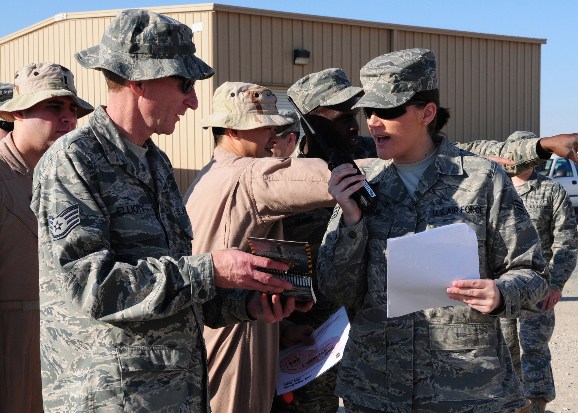 SOUTHWEST ASIA  -- Staff Sgt. Gary Elliot (left), 386th Expeditionary Civil Engineer Squadron, assists Senior Airman Joy Teague, 386th Expeditionary Operations Support Squadron, in identifying an unexploded ordnance, during a post attack reconnaissance training class here Dec. 29, 2009. The first section of the two-part training gives personnel a refresher and general overview of PAR team expectations. Sergeant Elliot is a structures technician from the Will Rogers Air National Guard unit in Oklahoma City, while Airman Teague is a knowledge operator from Pope Air Force Base, N.C. (U.S. Air Force photo/Staff Sgt. Lakisha A. Croley)
