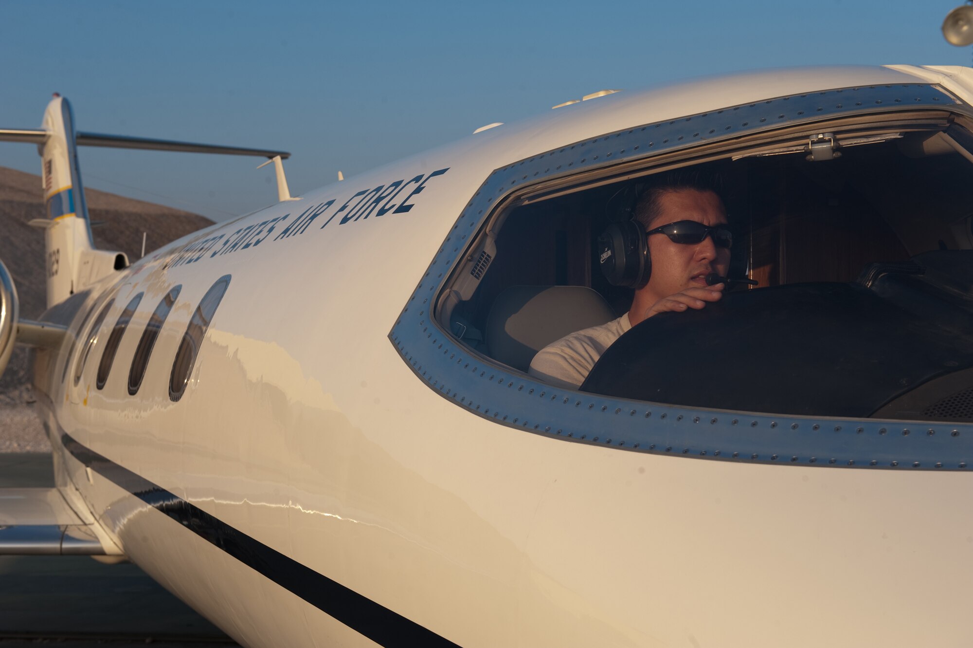 Mr. Dan Veloso, Dyncorp airframe and power plant mechanic, troubleshoots the radio system on a C-21, Dec. 27, 2009, in Southwest Asia. Dyncorp contractors provide total aircraft system maintenance services, logistical support, and management processes to maintain the C-21 fleet in operation throughout the U.S. Central Command area of responsibility. (U.S. Air Force photo/Staff Sgt. Robert Barney/RELEASED)