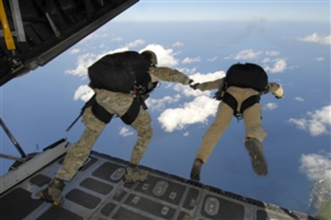 U.S. Air Force Lt. Col. Stephen Goodman and Capt. Robert Wilson perform a high-altitude, low-opening jump over Le Shima Island, Japan, Dec 23, 2009. The jump was part of routine training for the 31st and 320th special tactics squadrons from Kadena Air Base, Japan. Goodman and Wilson are assigned to the Air Force’s 31st Rescue Squadron. 
