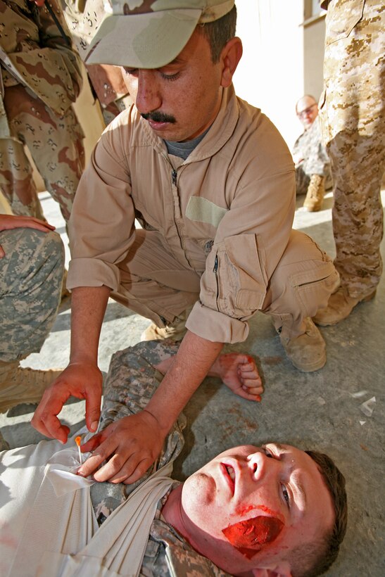 Iraqi soldiers rescue simulated casualties during a Combat Lifesaver Course aboard Camp Mejid, Iraq, Dec. 31, 2009.