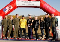 Participants and organizers of the Helping Heros Run gathered at the finish line after the race.
