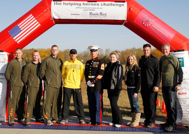 Participants and organizers of the Helping Heros Run gathered at the finish line after the race.