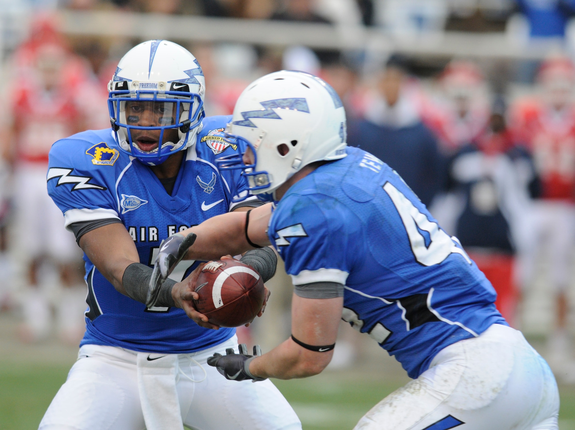 Falcons quarterback Tim Jefferson hands off to fullback Jared Tew during the Armed Forces Bowl in Fort Worth, Texas, Dec. 31, 2009. Tew, a junior and native of Park City, Utah, had 175 rushing yards against the Houston Cougars in Air Force's 47-20 victory. Jefferson, a sophomore and Atlanta native, had a career-high 161 passing yards in addition to 37 yards and a touchdown on the ground. (U.S. Air Force photo/Bill Evans)