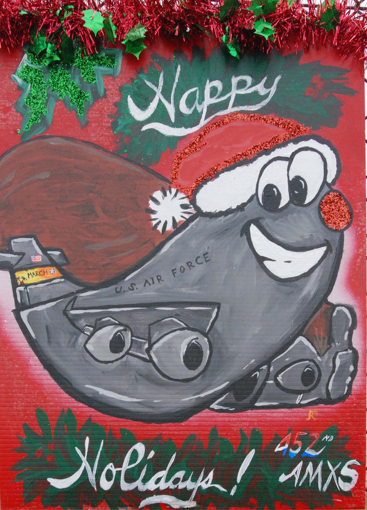 An oversize, handmade holiday greeting card lines greets Team March members as they enter and exit base Dec. 30, 2009.  Tech. Sgt. Neil Ballecer of the Blue Eagles Total Force Honor Guard at March Air Reserve Base, Calif., organized the display and more than 15 units from the base submitted cards.