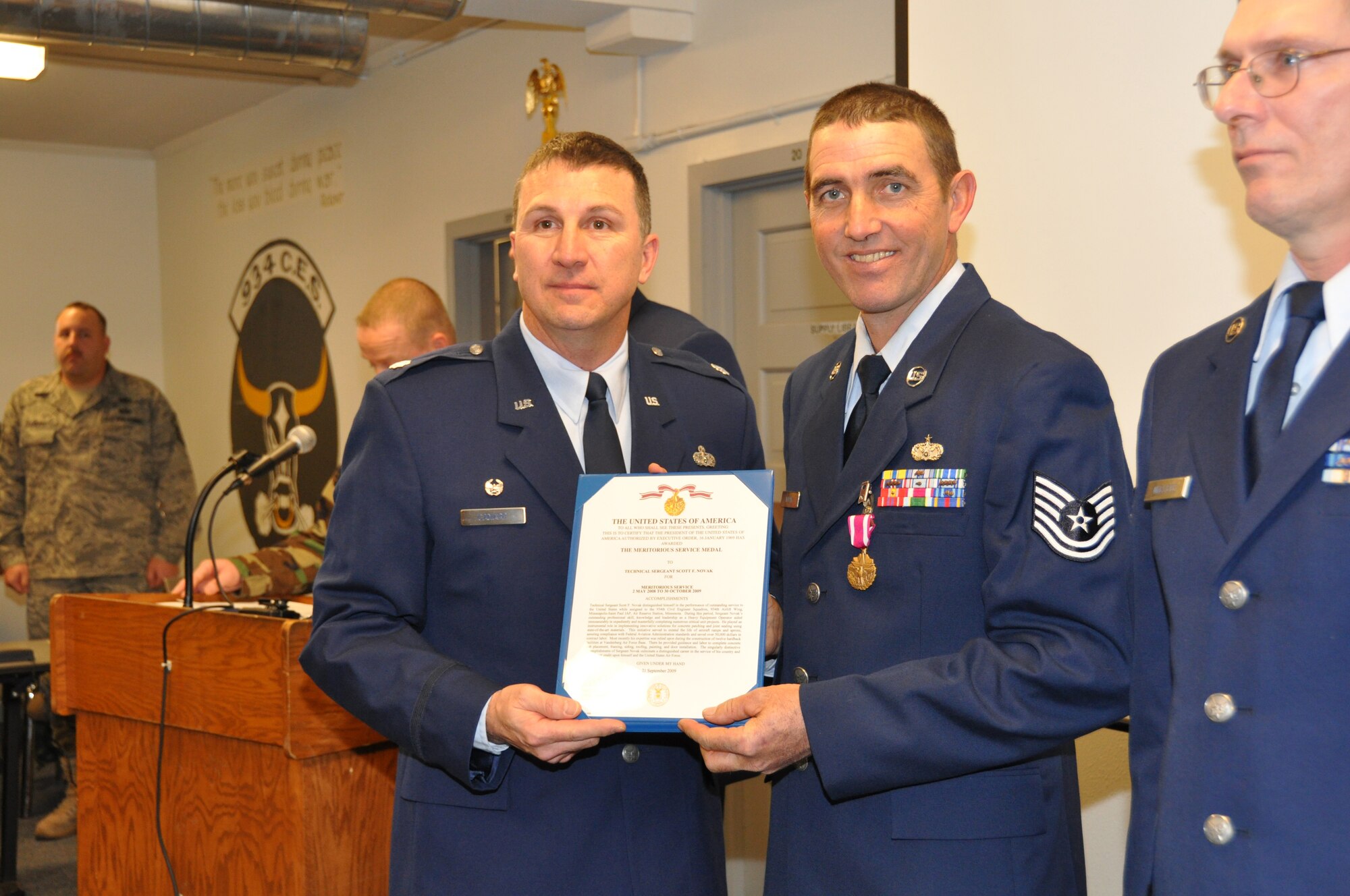 Tech. Sgt. Scott Novak, 934th Civil Engineer Squadron, receives the Meritorious Service Medal citation from Lt. Col. Les Canarr, 9344th CES commander, Nov. 7 at his retirement ceremony. Sergeant Novak retired with more than 22 years of service. (Air Force Photo/Senior Airman Noah Johnson)