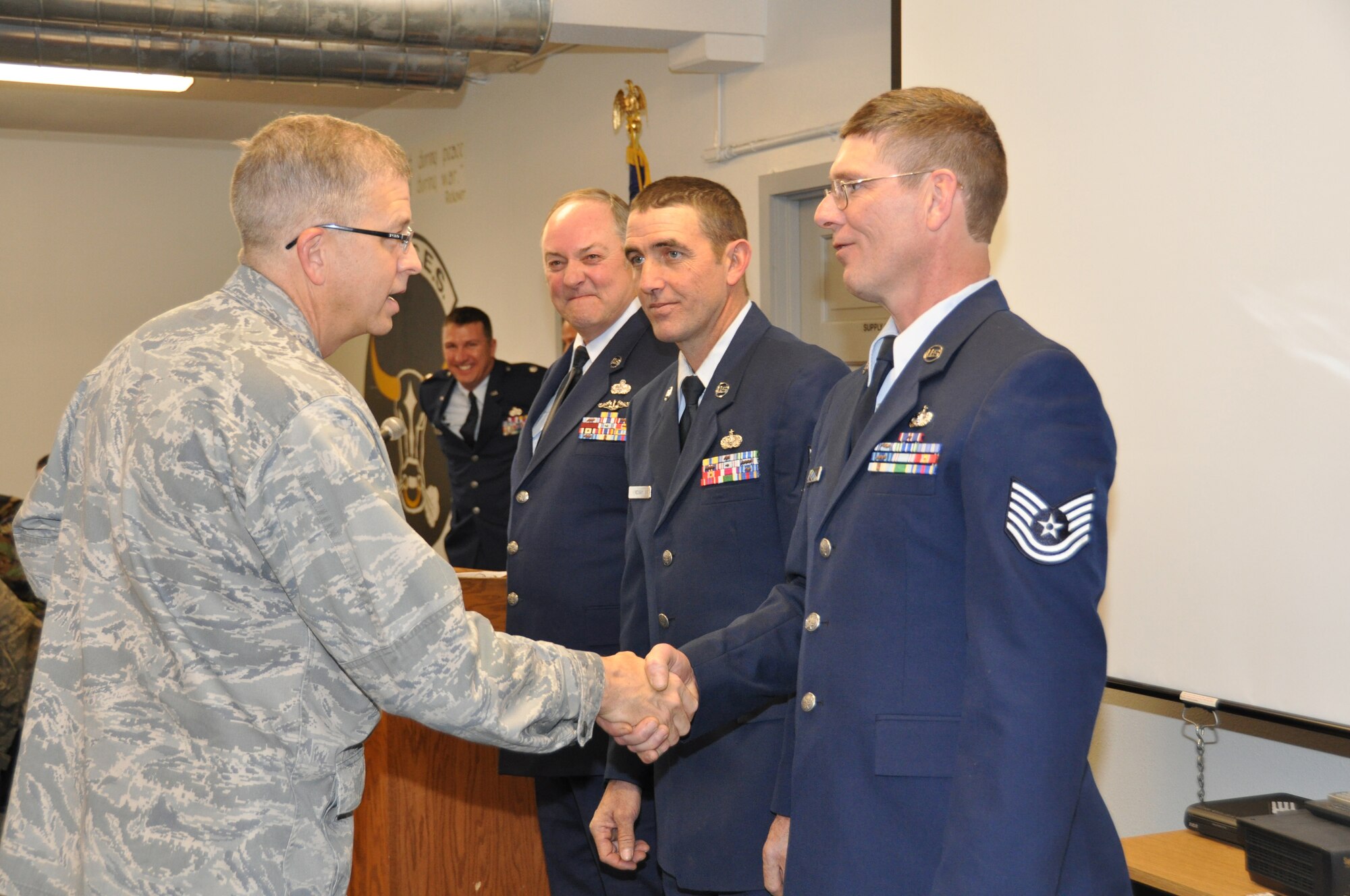 Tech. Sgt. John McEliece is congratulated on his retirement Nov. 7 by Col. Tim Tarchick, 934th Airlift Wing Commander. Sergeant McEliece retired with more than 29 years of service. (Air Force Photo/Senior Airman Noah Johnson) 