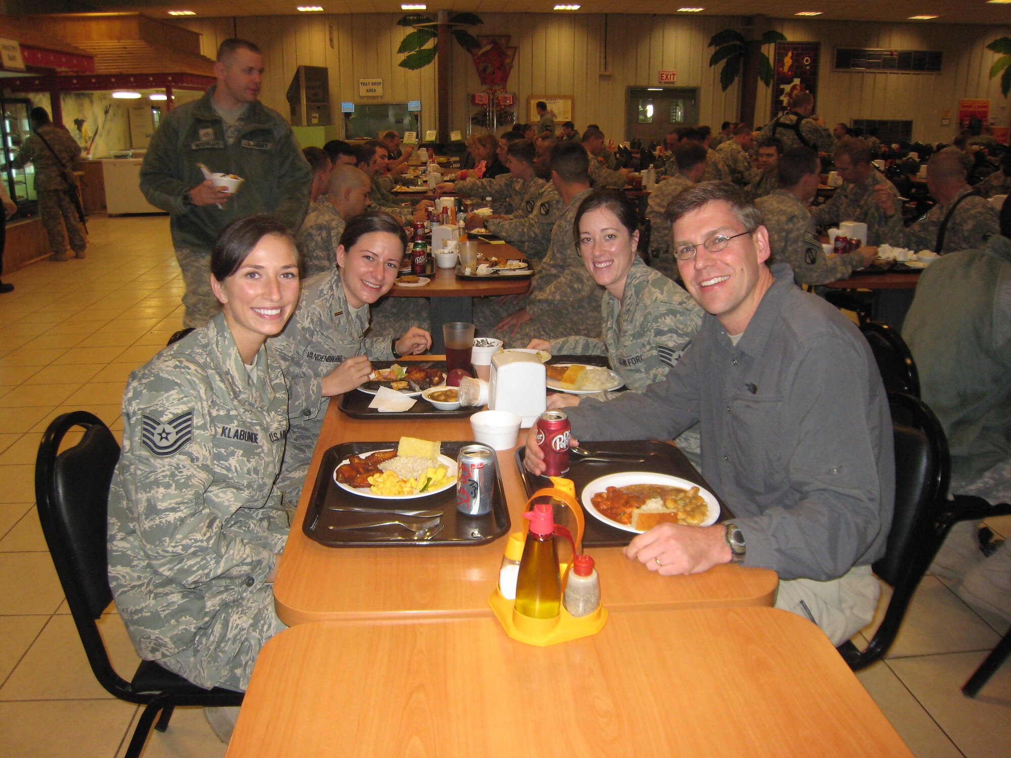 (Left to right) Tech. Sgt. Michelle Klabunde, 934th Aeromedical Staging Squadron;  Minnesota  National Guard member 2nd Lt. Tiffany Van Den Broeke, and Staff Sgt. MacKenzie Schroeder, 934th ASTS, enjoy a meal with Congressman Erik Paulsen, (3rd District Minn.) at their deployed location in Southwest Asia.  The congressman spent time touring facilities and talking with deployed military members. (Courtesty Photo)