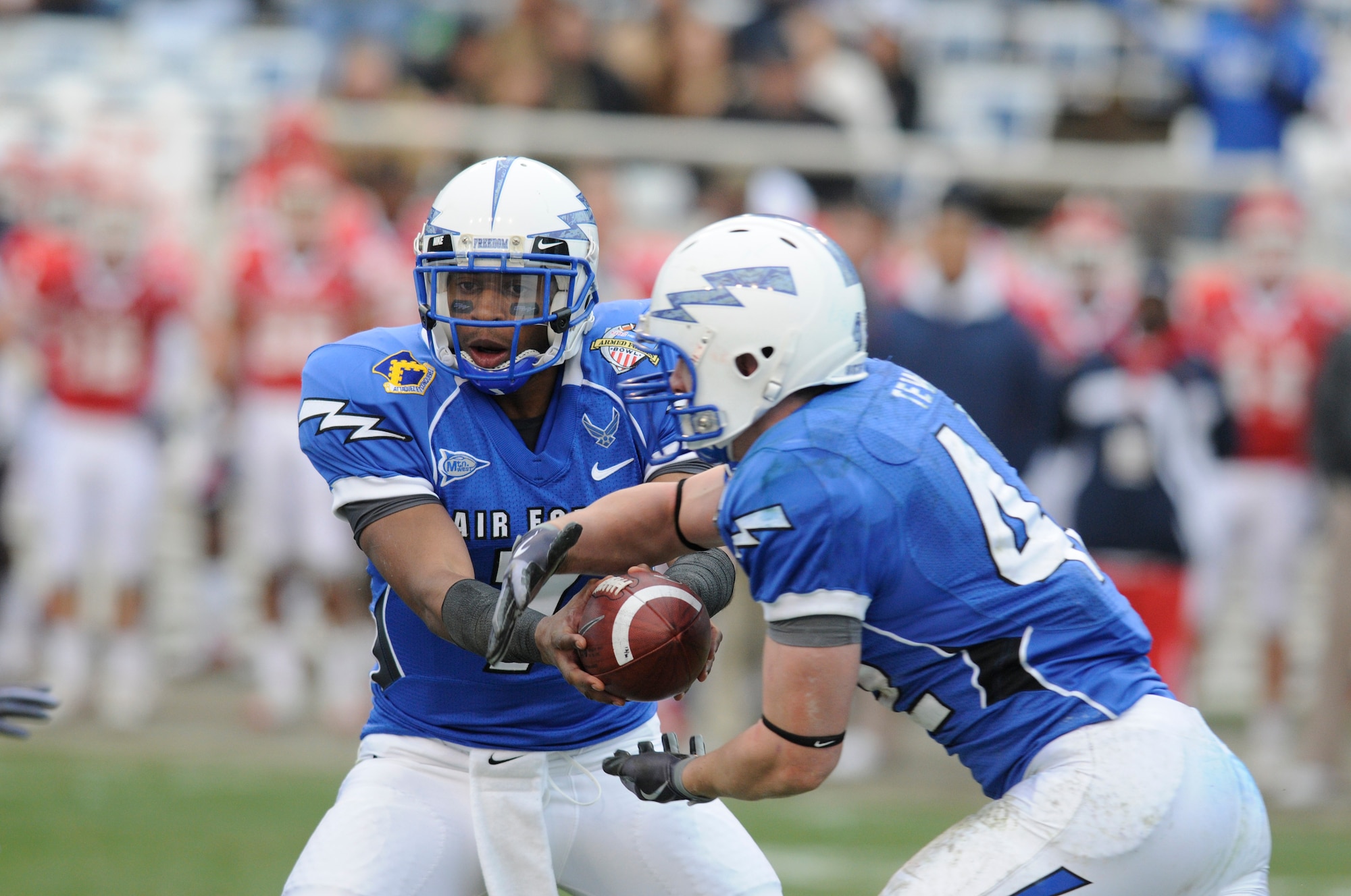 Falcons quarterback Tim Jefferson hands off to fullback Jared Tew during the Armed Forces Bowl Dec. 31, 2009, at Fort Worth, Texas. The U.S. Air Force Academy triumphed over the University of Houston Cougars, 47-20. (U.S. Air Force photo/Bill Evans)
