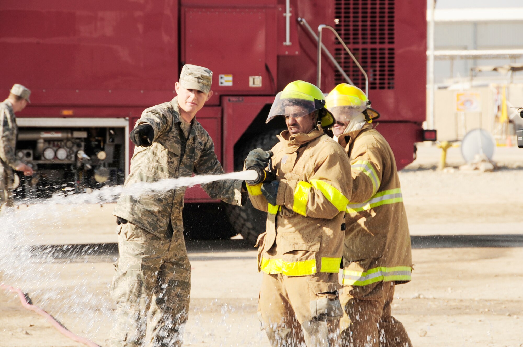 Airman 1st Class Sean Piper provides fire training to Iraqi firefighters, Dec. 28, 2009 at Camp UR, Iraq. The Airmen provide training to the Iraqi Army fire department three times a week to ensure Iraqi firefighters are self sufficient. Airman Piper is from the 407th Expeditionary Civil Engineer Squadron fire department. (U.S. Air Force photo/Master Sgt. Darrell Habisch)