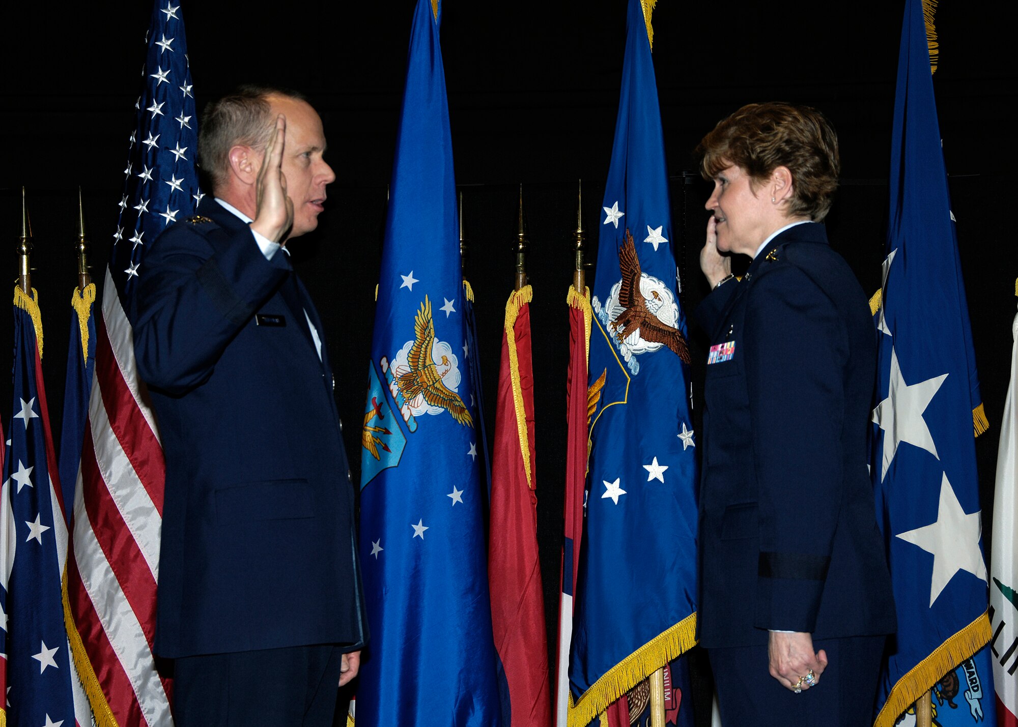 Gen. Donald J. Hoffman, commander of Air Force Materiel Command, re-administers the oath of office to Lt. Gen. Janet C. Wolfenbarger during a Dec. 30 promotion ceremony at the National Museum of the United States Air Force.  General Wolfenbarger's new three-star rank and position as the Vice Commander of AFMC were confirmed by the U.S. Senate Dec. 4.  (U.S. Air Force Photo/Mike Libecap)