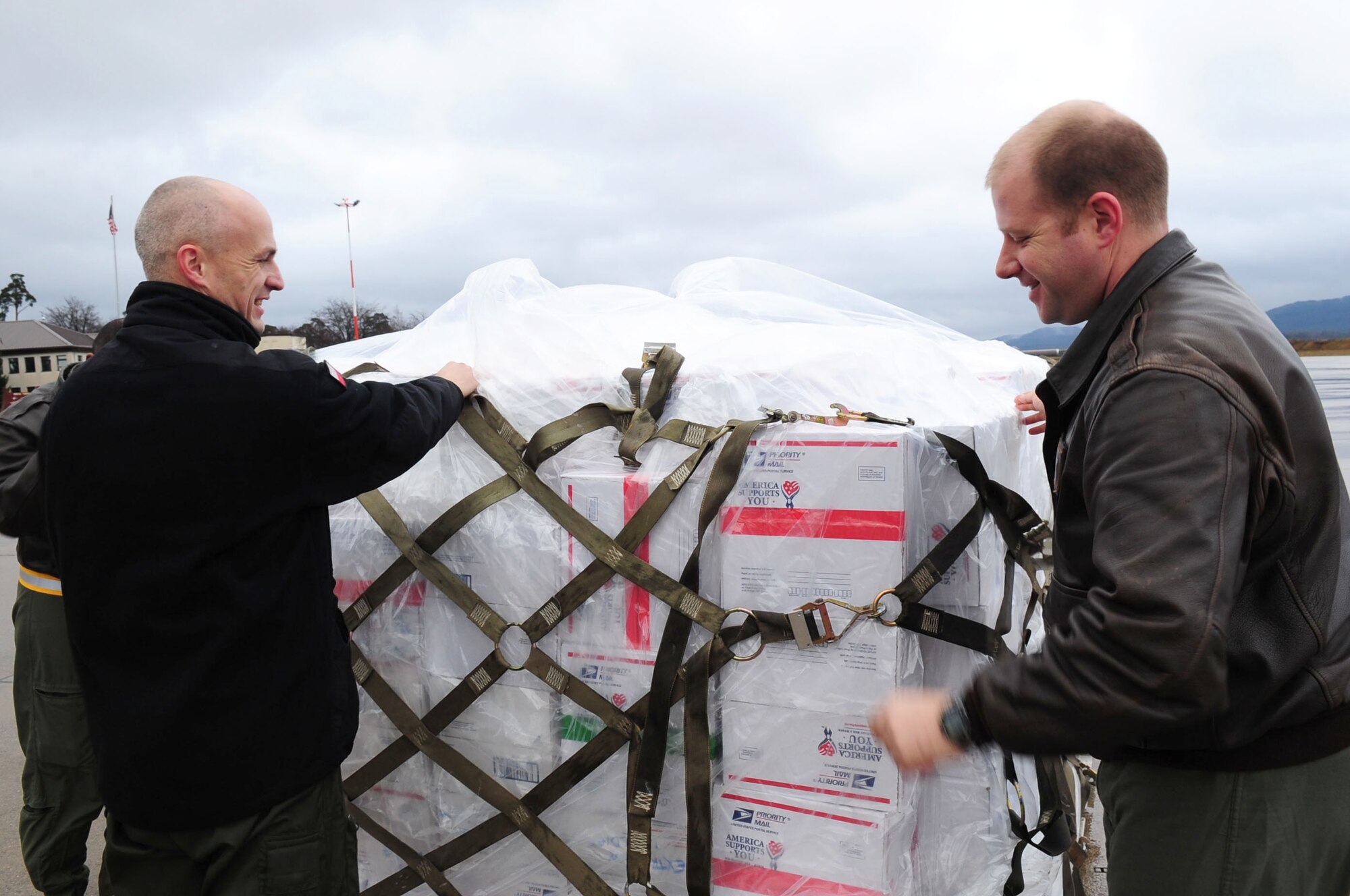 U.S. Air Force Tech. Sgt. Scott Schlup, a load master with the 37th Airlift Squadron assists a member of the Polish Air Force prepare a pallet for transport on a  Polish Air Force's Casa 295 at Ramstein Air Base, Germany on Dec. 31, 2009. The pallet packed with care packages from the U.S. is to be transported to Polish troops stationed in Afghanistan. The 2,000 packages will be delivered by Polish military airlift and were donated by the American Polish Forum in the U.S. The packages contain sweets and comforts items, as well as a handwritten card and a "oplatek (OH-PWA-TEK)," a traditional Polish wafer shared on Christmas Eve. Held under the slogan Adopt a Polish Soldier, the care-package initiative is financed by $25 donations collected
from people across the world.  The humanitarian mission has gained the support from foreign affairs officials both in Washington and Warsaw, with backing from former U.S. National Security Adviser Zbigniew Brzezinski. (U.S. Air Force photo by Staff Sgt. Jocelyn Rich) 

