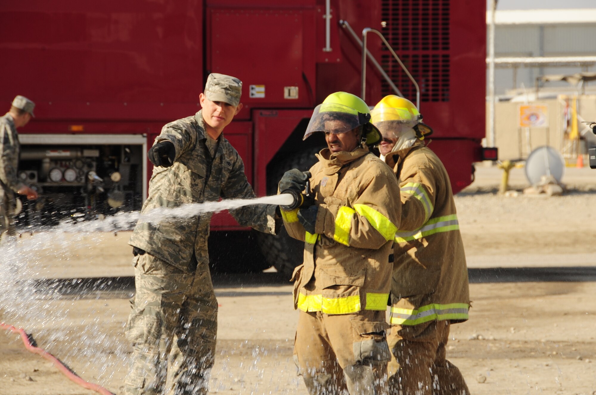 CAMP UR, Iraq - Airman 1st Class Sean Piper, 407th Expeditionary Civil Engineer Squadron fire department, provides fire training to Iraqi firefighters, Dec. 28, 2009.  The Airmen provide training to the Iraqi Army fire department three times a week to ensure Iraqi firefighters are self sufficient.  (U.S. Air Force photo/Master Sgt. Darrell Habisch) 