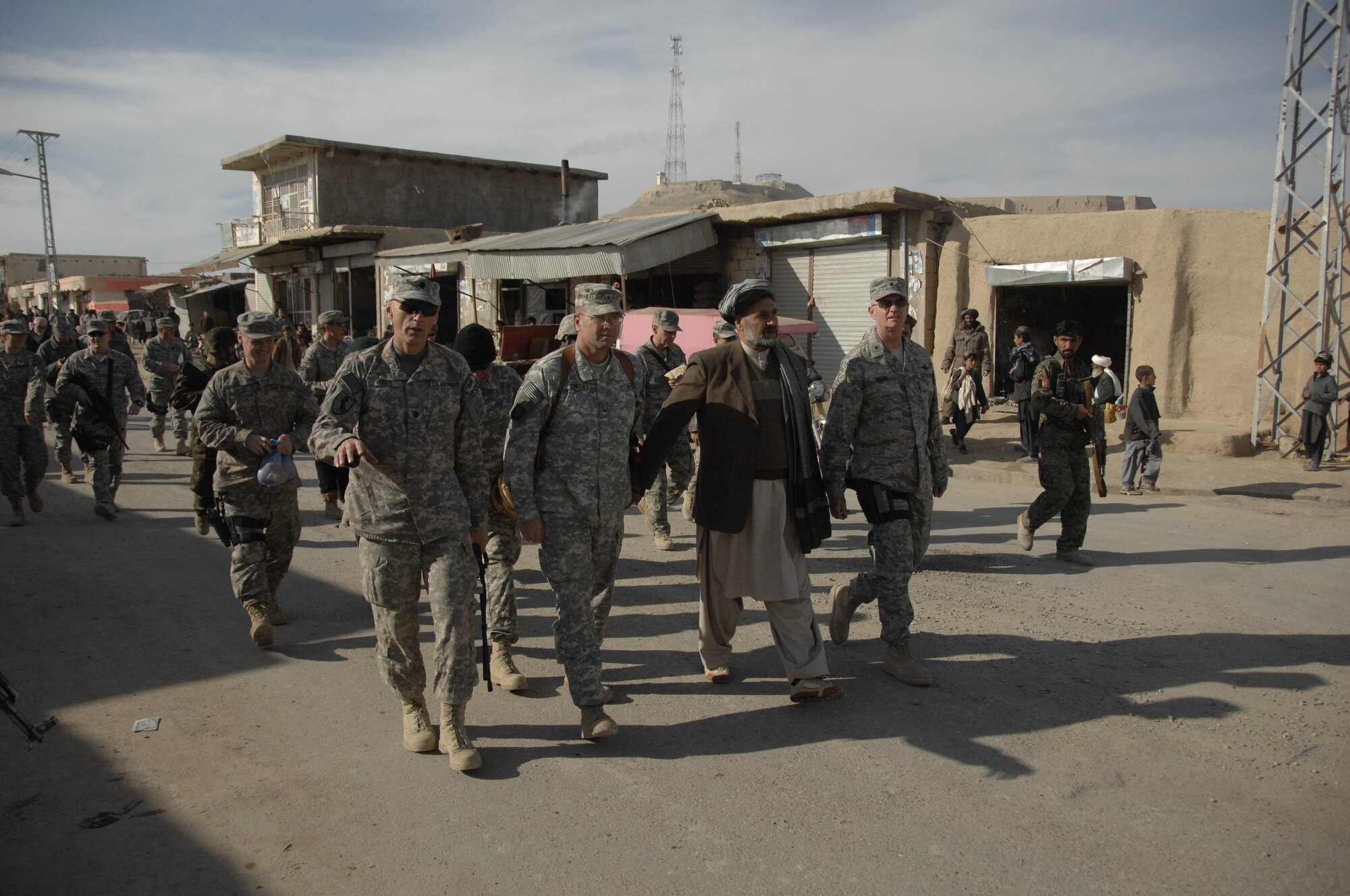 ZABUL PROVINCE, Afghanistan -- Lt. Col. Andy Veres, commander of Provincial Reconstruction Team Zabul, Brig. Gen. Frederick Hodges, director of operations for Regional Command South, Zabul’s Provincial Governor Mohammad Ashraf Naseri, and Brig. Gen. Guy Walsh, 451st Air Expeditionary Wing commander, walk down the new bazaar street in Qalat Dec. 26, 2009.  Governor Naseri held the hand of General Hodges for a few moments as they walked the street of Qalat.  According to Afghan custom and as a gesture of friendship, this was proof of the partnership that exists between the U.S. and Afghan people. (U.S. Air Force photo/Senior Airman Timothy Taylor)