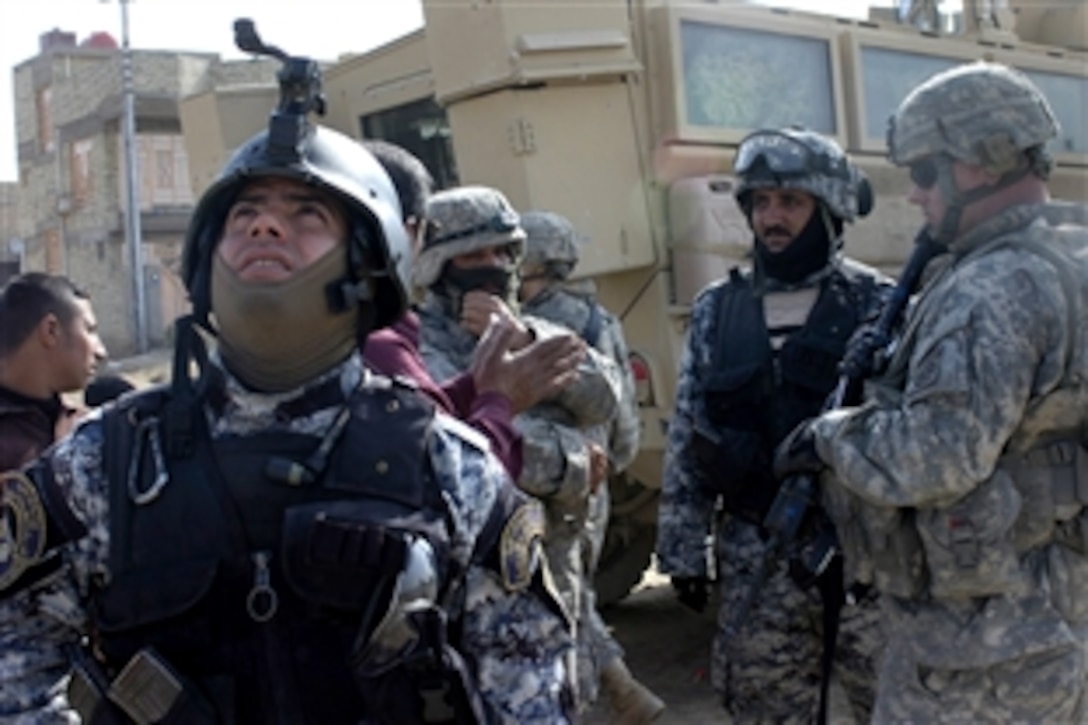 Iraqi National Police officers partnered with paratroopers assigned to the  82nd Airborne Division's 3rd Brigade Combat Team to conduct security operations outside a polling station in eastern Baghdad, Jan. 31, 2009. The U.S. soldiers assisted Iraqi security forces during the provincial elections.