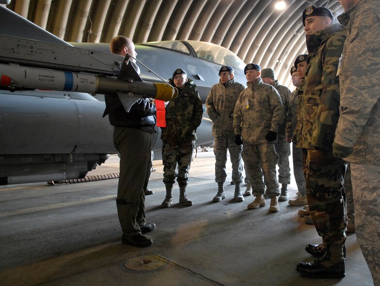 Capt. Patrick Lysaght explains the capabilities of the F-16 Falcon to a tour of 51st Security Forces Squadron Airmen Jan. 23 at Osan AB. The tour was part of an open house hosted by the 36th Fighter Squadron that is designed to give Airmen across the base an opportunity to learn more about the squadrons they support. Captain Lysaght is assigned to the 36 FS at Osan AB. (U.S. Air Force photo/Staff Sgt. Brian Ferguson)