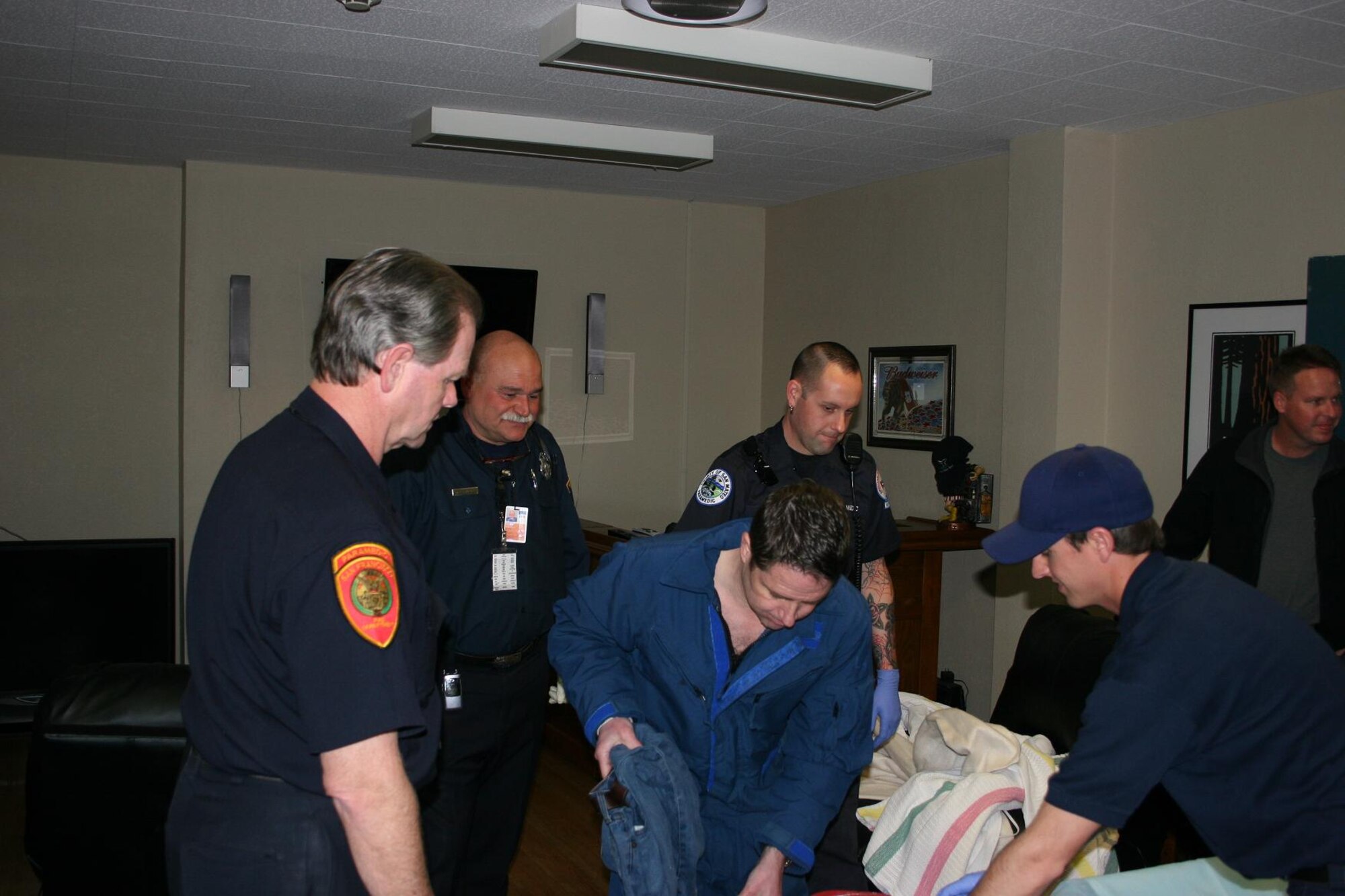 U.S. Coast Guard Air Station San Francisco personnel, emergency medical technicians, and the San Francisco Police Department help the survivor of a plane crash into a survival suit Jan. 29. The survival suit was used to help raise his body temperature after the onset of hypothermia. The pilot lost power to his single engine plane about 10 miles west of Pillar Point, and was rescued by a 129th Rescue Wing HH-60G Pave Hawk crew. (U.S. Coast Guard photo by Lt. j.g. Ryan Hawn) 