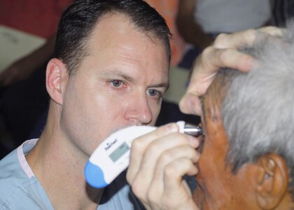 Choluteca, Honduras - Dr. (Maj.) John Thordsen Ochoa, an ophthalmologist from Madigan Army Medical Center, Wash., checks pressure in Damaso Sosa's eye after removing a cataract Jan. 27.  Dr. Thordsen led a 17-person surgical ophthalmology team performing a Medical Readiness and Training Exercise here Jan. 8-30.  (US Air Force photo/Tech. Sgt. Rebecca Danét)