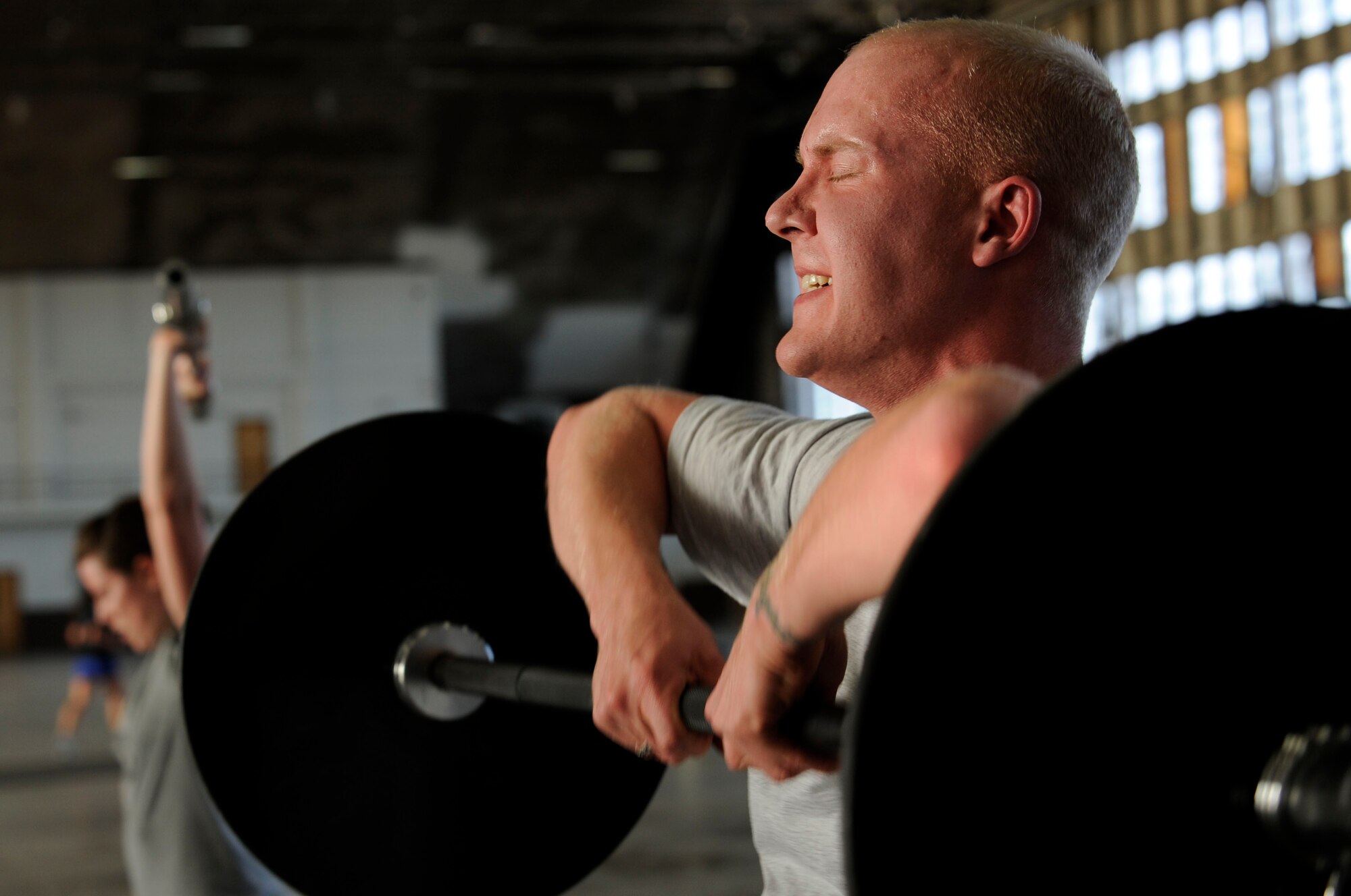 Senior Airman Marc Lane, 28th Bomb Wing Public Affairs still photographic journeyman, performs a deadlift high-pull during the Fight Gone Bad crossfit tournament here, Jan. 30. The Fight Gone Bad workout mimics mixed-martial arts training and consists of five exercises, performed for one minute each, with one-minute breaks given after all exercises have been completed. (US Air Force photo/Airman 1st Class Corey Hook)