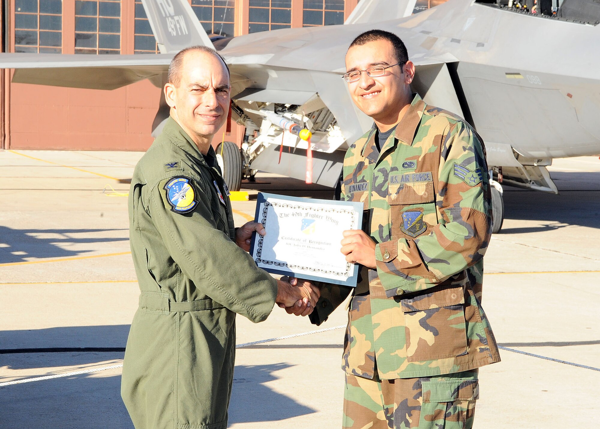 49th Fighter Wing commander, Col. Jeff Harrigian, presents a certificate of recognition to Senior Airman Toby Hernandez, 49th Aircraft Maintainance Squadron, at the Load Crew of the Year competition at Holloman Air Force Base, N.M., Jan. 30. Airman Hernandez was being recognized for the effort given at the competition. (U.S Air Force photo/ Airman 1st Class DeAndre Curtiss)