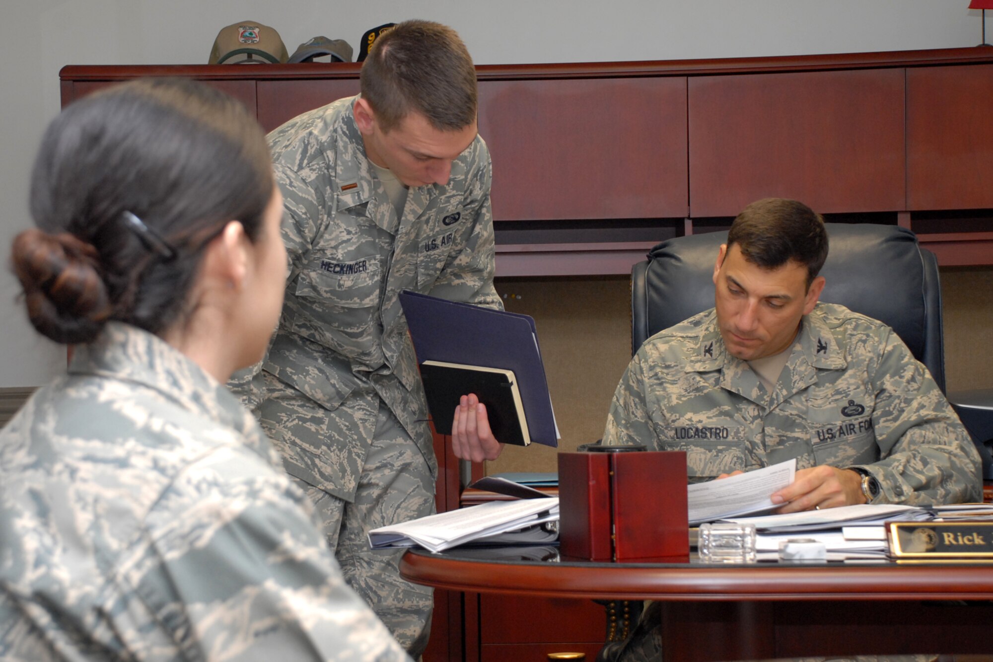 EGLIN AIR FORCE BASE, Fla. -- Second Lt. Jonathan Heckinger, 96th Air Base Wing executive officer, gets some direction from Col. Rick LoCastro, 96th Air Base Wing vice commander, while 2nd Lt. Jennifer Lozano watches the exchange Jan. 27. Lieutenant Lozano spent the day shadowing the colonel as a part of the Shadow Week Program. Shadow Week, a quarterly program organized by Eglin's Junior Force Council, helps bridge the gap between Eglin's senior leaders and its junior forces by sharing Air Force experiences, life lessons and career choices. According to the intent of the program, shadowing a senior leader gives the junior force counterpart the opportunity to see their leader in action, as well as get advice on their own careers. (U.S. Air Force photo by Staff Sgt. Mike Meares)