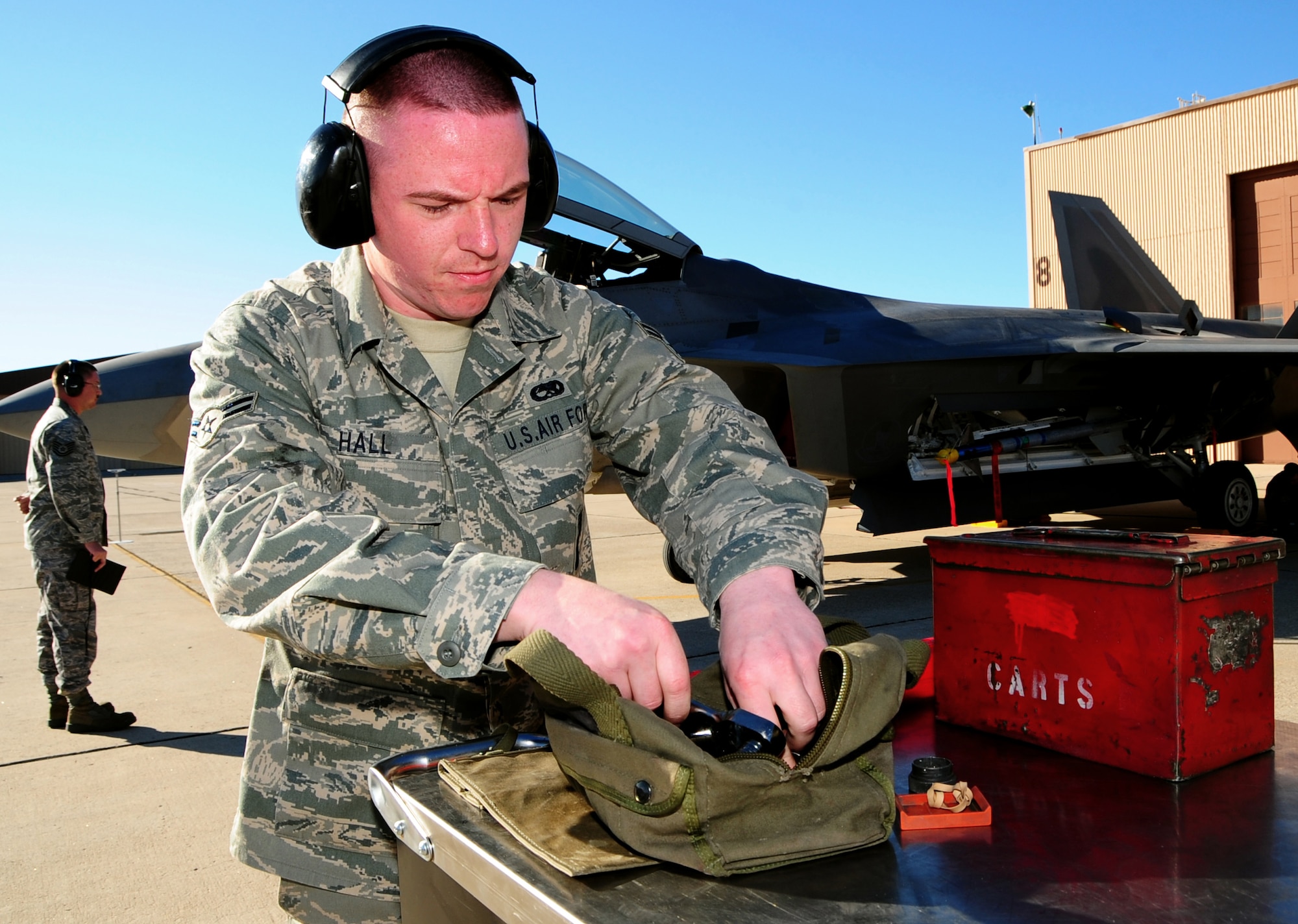 Airman 1st Class Justin Hall prepares an F-22A Raptor to be loaded with bombs while competing in the Load Crew of the Year competition at Holloman Air Force Base, N.M. Airman Hall works for the 49th Aircraft Maintenance Squadron as a 7th Weapons 1 Man Loadcrew Member. (U.S. Air Force photo/Tech. Sgt. Chris Flahive)
