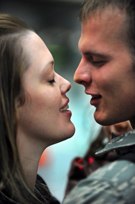 Senior Airman William Seaborne, 28th Air Maintenance Squadron hydraulics systems journeyman, kisses his wife, Shaina, upon his return from a six-month deployment to Southwest Asia here, Jan. 31. While deployed, Airman Seaborne provided support to Operations Iraqi and Enduring Freedom. (US Air Force Photo/Airman 1st Class Adam Grant)  