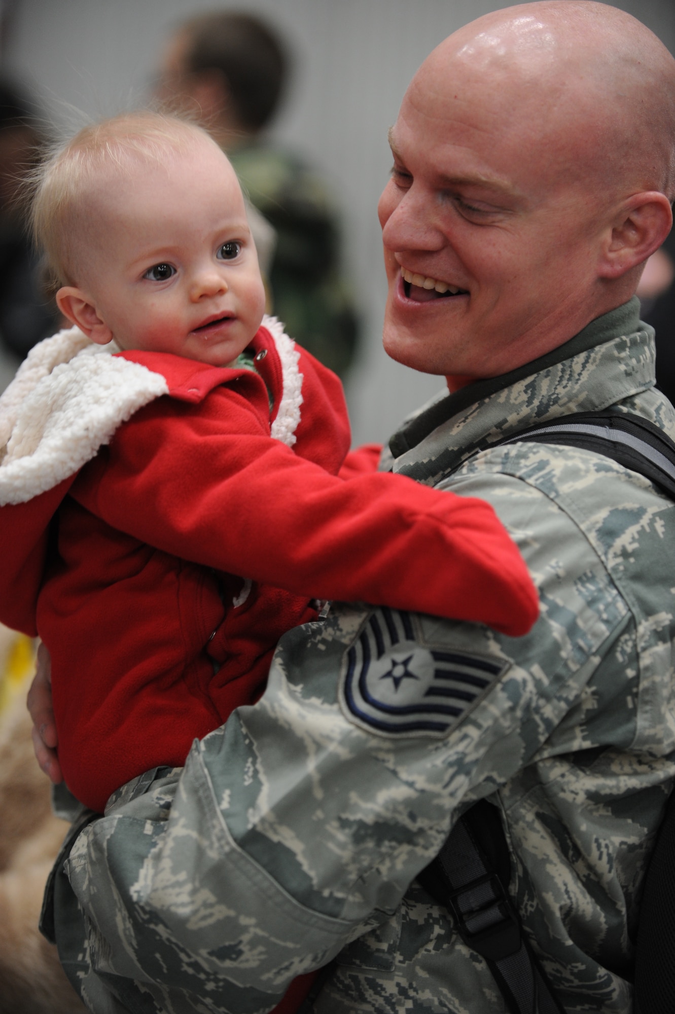 Tech Sgt. Jason Nardi, 28th Maintenance Operations Squadron aircraft armor systems craftsman, gives his son, Vance, a hug upon arrival from his six-month deployment to Southwest Asia here, Jan. 31. While deployed, Asia, Sergeant Nardi provided weapons support to Operations Iraqi and Enduring Freedom. (US Air Force Photo/Airman 1st Class Adam Grant) 