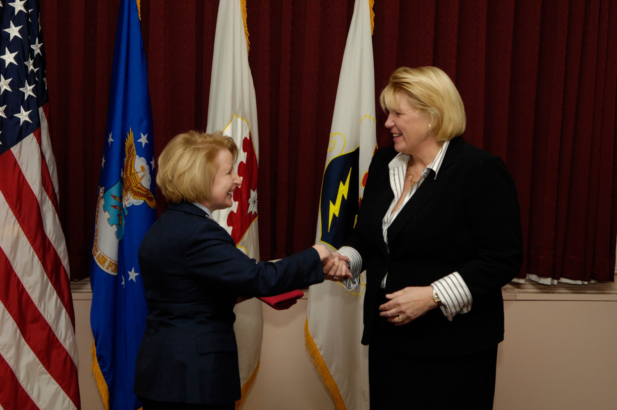 HANSCOM AIR FORCE BASE, Mass. - Col. Deborah Van De Ven (left), 66th Mission Support Group commander, congratulates Maureen Sullivan, Bedford Chamber of Commerce executive director, on her induction into Hanscom's Honorary Commander Program, Jan. 30, during a ceremony at the Hanscom Minuteman Club. Ms. Sullivan will serve a two-year term as Honorary Commander for the 66th Mission Support Group.  (U.S. Air Force photo by Mark Wyatt)  