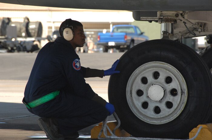 NELLIS AIR FORCE BASE, Nev. – Staff Sgt. Demetric Byrd, 335th Fighter Squadron crew chief, Seymour Johnson AFB, N.C., prepares to pull chalks on an F-15 E before a mission here Jan. 28 in support of RED FLAG 09-2.  RED FLAG is a multinational exercise providing a realistic environment to practice combat scenarios.  The experience gained during the exercise is vital to the survival of the pilots in combat.(U.S. Air Force photo by 2nd Lt. Noelle Caldwell)