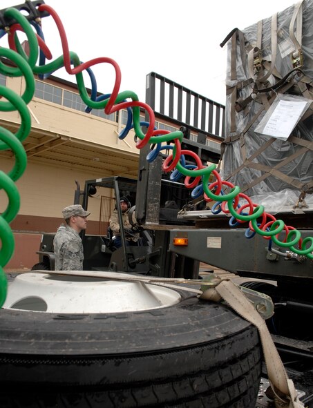 Adam Dutcher and Senior Airman Heath Barker, 2d Logistics Readiness Squadron, load cargo in order to relocate it from 2d LRS to the Marshalling yard located on the flightline. The cargo move is being performed in support of Barksdale's Conventional Operational Readiness Exercise. Airman 1st Class Brittany Y. Bateman/U.S. Air Force