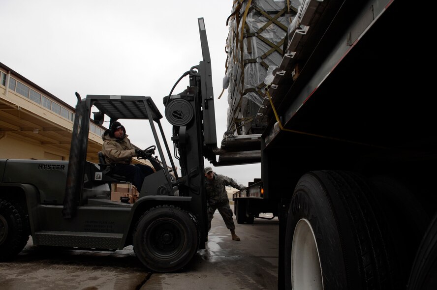 Senior Airman Dustin Haub assists Adam Dutcher, 2d Logistics Readiness Squadron, as he loads cargo in order to relocate it from the 2d LRS to the Marshalling yard located on the flightline. The cargo move is being performed in support of Barksdale's Conventional Operational Readiness Exercise. Airman 1st Class Brittany Y. Bateman/U.S. Air Force