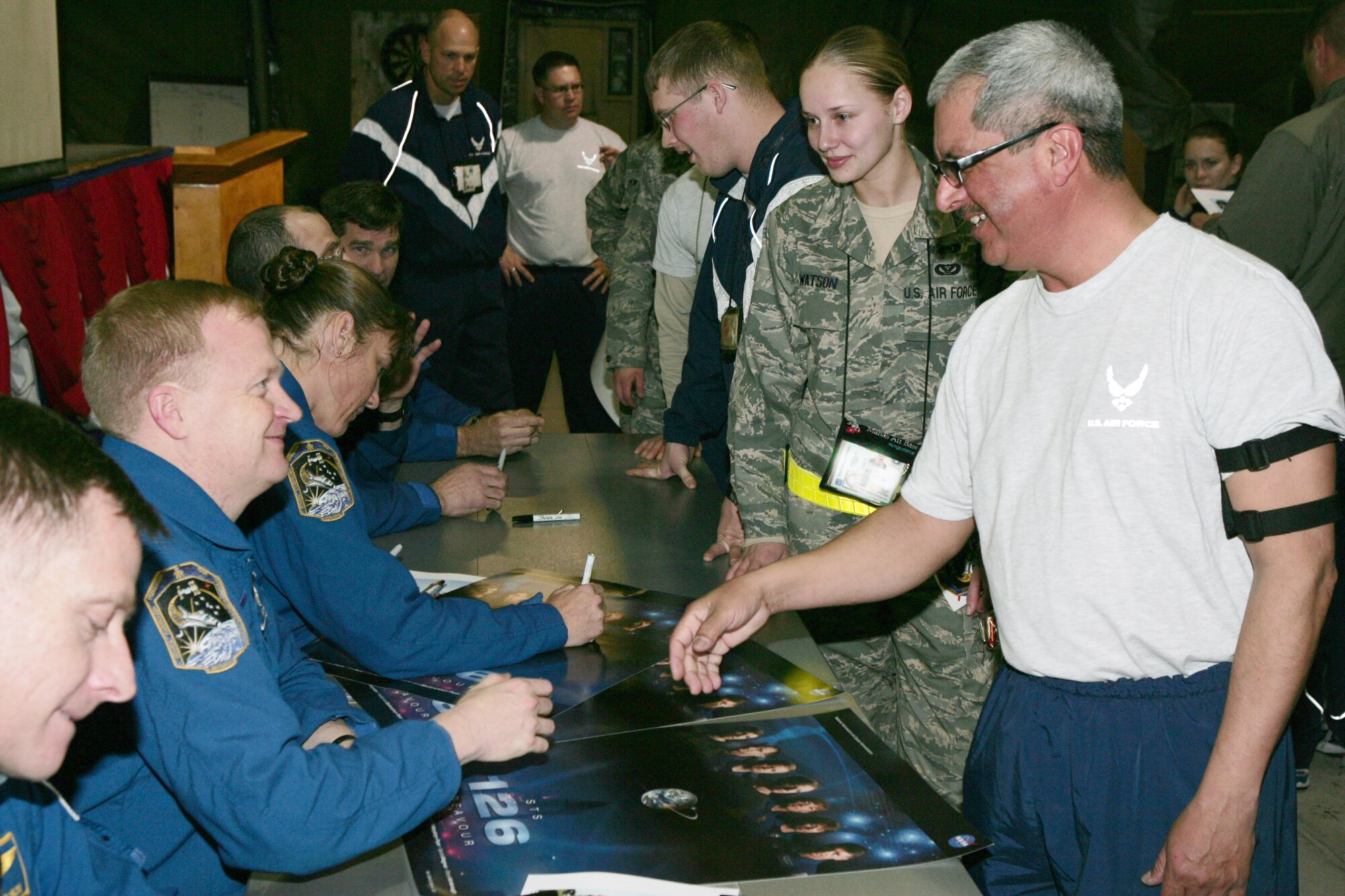 The crew of NASA's Space Shuttle Endeavour STS-126 mission sign autographs for and visit with Airmen during their visit to Manas Air Base, Kyrgyzstan, Jan. 28. The visit marked the first time NASA astronauts have toured the deployed area of operations after a mission. (U.S. Air Force photo/Tech. Sgt. Elizabeth Weinberg) 