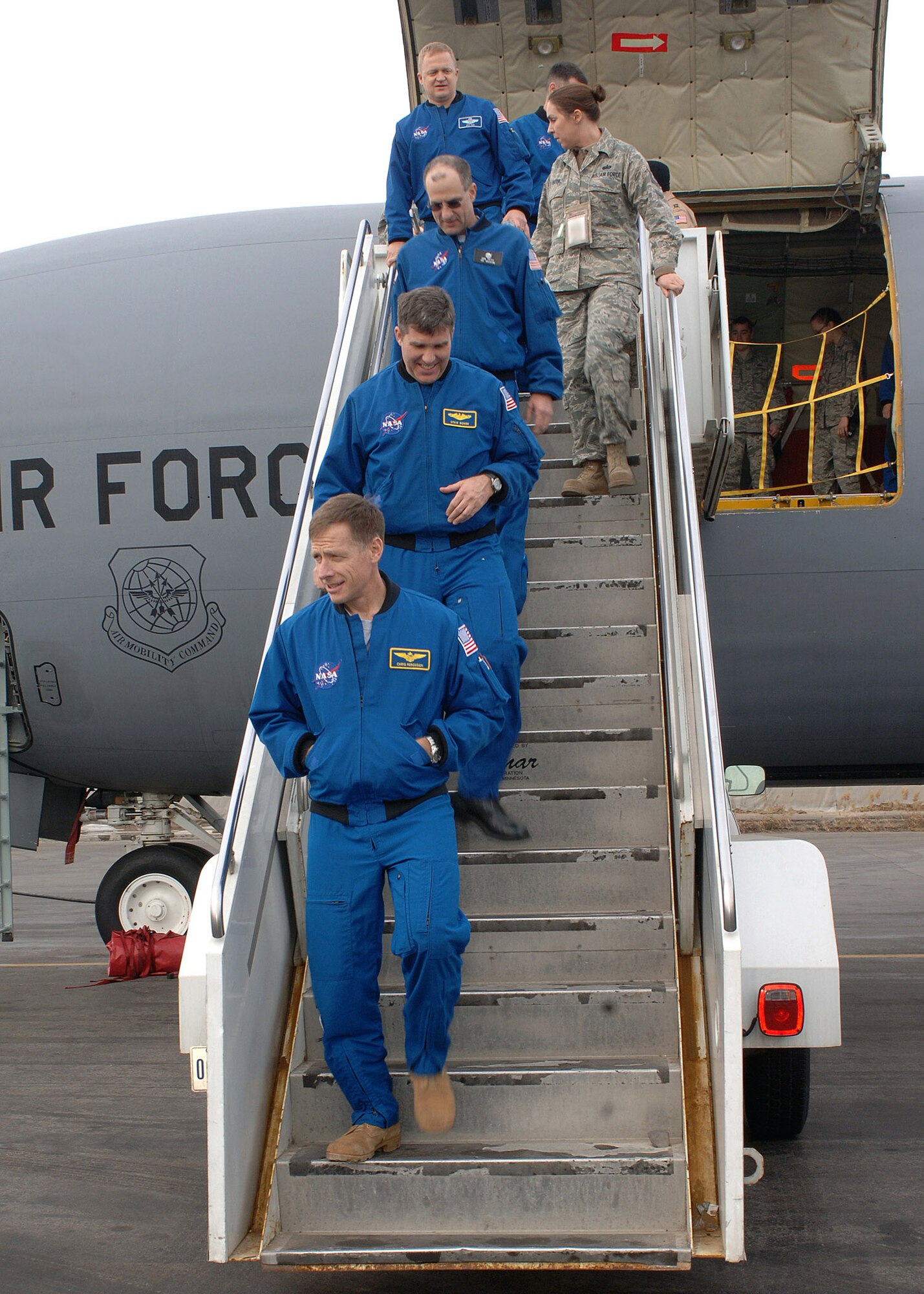 The crew of NASA's Space Shuttle Endeavour STS-126 mission step off a KC-135 Stratotanker after a tour of the aerial refueler at Manas Air Base, Kyrgyzstan, Jan. 28. The visit was the first time NASA astronauts have toured the deployed area of operations after a mission and marked the first time astronauts have ever visited Manas AB or the country of Kyrgyzstan. (U.S. Air Force photo/Tech. Sgt. Elizabeth Weinberg) 