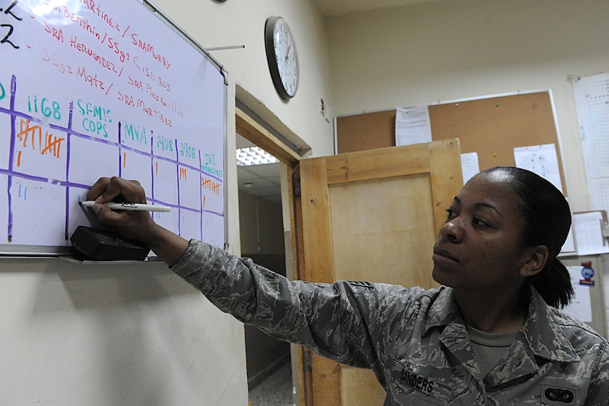 JOINT BASE BALAD, Iraq -- Staff Sgt. Jessica Sanders, a security forces leader with the 332nd Expeditionary Security Forces Squadron, updates a personnel board, here, Feb. 2. The board tracks where personnel are patrolling around JBB. (U.S. Air Force photo/Senior Airman Tiffany Trojca)