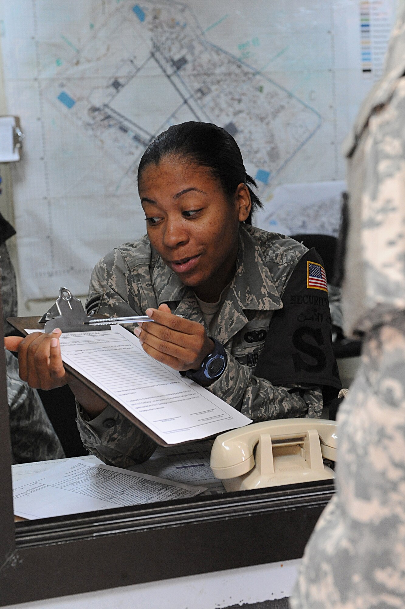 JOINT BASE BALAD, Iraq -- Staff Sgt. Jessica Sanders, a security forces leader with the 332nd Expeditionary Security Forces Squadron, instructs a servicemember on how to file a missing identification card worksheet, here, Feb. 2. Sanders is the Tuskegee Airman of the week for Jan. 19-25. (U.S. Air Force photo/Senior Airman Tiffany Trojca)