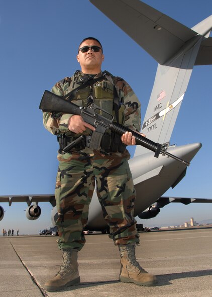 During a Major Accident Response Exercise "MARE" at Travis Air Force Base on 13 January 2009, Technical Sergeant Efren Rugnao scans the flight line, checking for any unauthorized personal within or close to the secured perimeter of a C-17 Aircraft.  TSgt Rugnao is a member of the 55th Aerial Port Squadron and also works as a Security Forces Augmentee when he is needed on a security operation.  (U.S. Air Force photo by Civ/Nan Wylie)