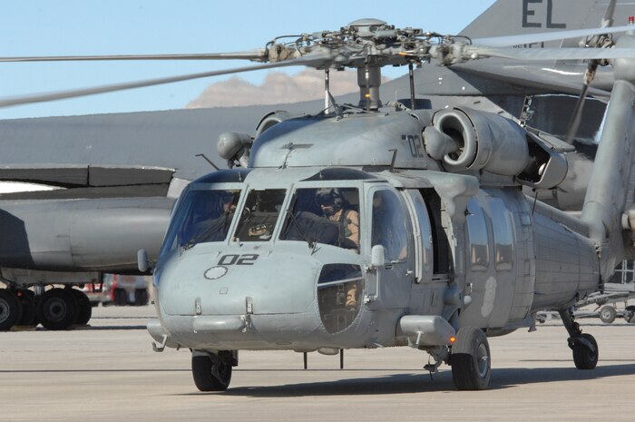 NELLIS AIR FORCE BASE, Nev. – U.S. Navy pilot Cmdr. Don Mendler, (left) Helicopter Support Combat Squadron 85, North Island, San Diego, Calif., and U.S. Navy co-pilot Lt. Cmdr. James MacDonald (right), HSC 85, guide their helicopter to park after returning from a mission for RED FLAG 09-2.  RED FLAG is a multinational exercise providing a realistic environment to practice combat scenarios.  The experience gained during the exercise is vital to the survival of the pilots in combat.