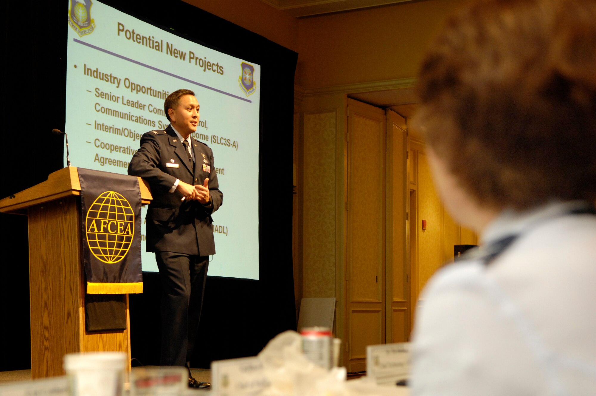 Col. Cordell DeLaPena, commander of the 653rd Electronic Systems Group, addresses the nearly 600 attendees at this year’s New Horizons Symposium at the Newton Marriot Jan. 28.  New Horizons is sponsored by the Lexington-Concord Chapter of the Armed Forces Communications and Electronics Association.