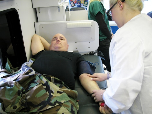 An Airman donates blood during the 452nd Air Mobility Wing Blood Drive inside a “Bloodmobile” parked at Bldg. 2340, Jan. 25. About 35 pints of blood was donated, according to Senior Master Sgt. Arvie McGinnis, blood drive coordinator. The blood will serve the Riverside and San Bernardino counties. The next March ARB drive will take place during the A UTA in the spring. (U.S Air Force photo by Senior Airman David Flaherty)