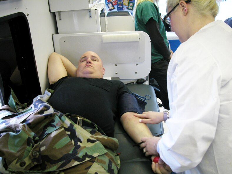 An Airman donates blood during the 452nd Air Mobility Wing Blood Drive inside a “Bloodmobile” parked at Bldg. 2340, Jan. 25. About 35 pints of blood was donated, according to Senior Master Sgt. Arvie McGinnis, blood drive coordinator. The blood will serve the Riverside and San Bernardino counties. The next March ARB drive will take place during the A UTA in the spring. (U.S Air Force photo by Senior Airman David Flaherty)