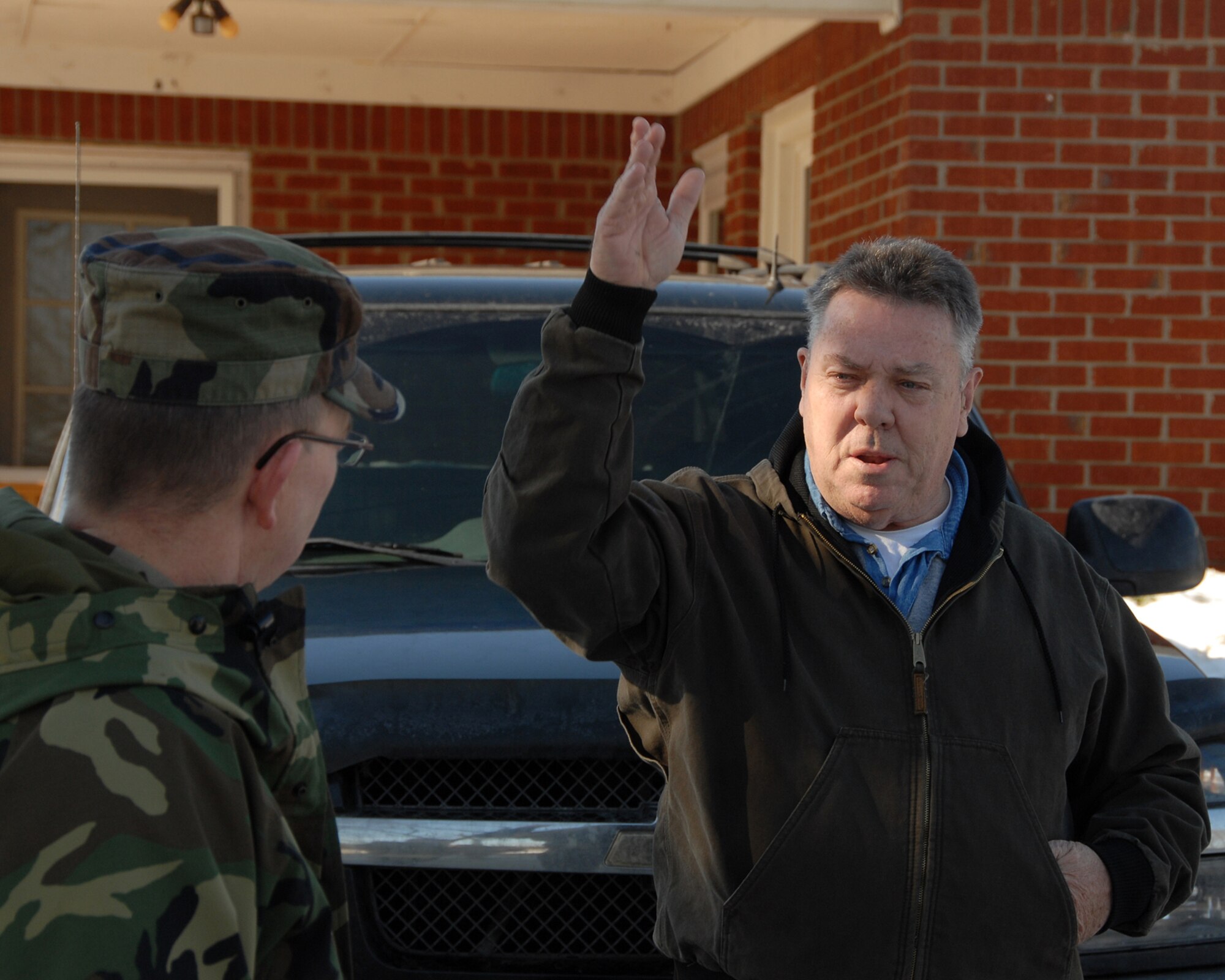 A McDaniels, KY., resident explains  his situation to a Kentucky Air Guardsman during a door-to-door "Wellness Check" of residents in the area during ice storm relief efforts.  (Photo by Tech. Sgt. Dennis Flora / KyANG)