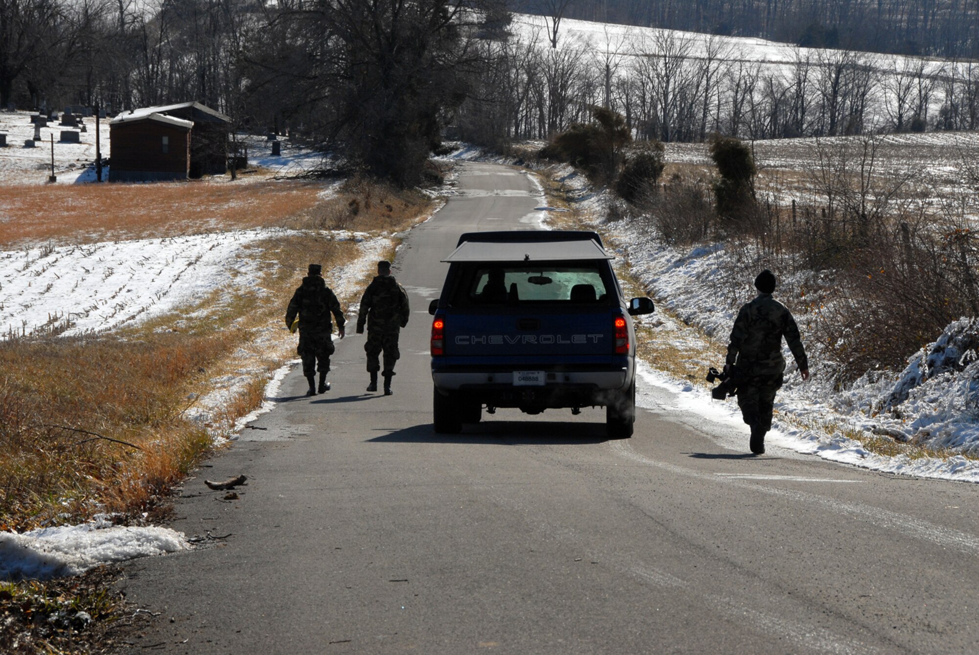 Members of the Kentucky Air National Guard walk rural roads of McDaniels, KY. providing "Wellness Checks" to its residents during emergency ice storm relief efforts.  (Photo by Tech. Sgt. Dennis Flora / KyANG)